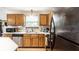 Well lit kitchen featuring white countertops, stainless steel appliances, wood cabinets, and updated sink at 4380 Dunsany Ct, Indianapolis, IN 46254