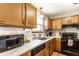 Functional kitchen with wooden cabinets, modern appliances, and a bright window above the sink for natural lighting at 4380 Dunsany Ct, Indianapolis, IN 46254