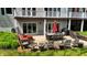 Backyard view with outdoor dining and patio seating area with manicured lawn at 4443 Mallard Pt, Columbus, IN 47201