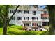 Backyard view with a well-manicured lawn and patio featuring outdoor dining and seating at 4443 Mallard Pt, Columbus, IN 47201