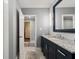 The bathroom has granite countertops, modern mirror, and tile floors with a doorway to an adjacent room at 4443 Mallard Pt, Columbus, IN 47201