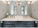 Close-up of a double sink vanity with marble countertop, stylish mirrors, and chrome fixtures at 4443 Mallard Pt, Columbus, IN 47201