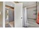 A bathroom with a bathtub, shower curtain, and a view into an adjacent room at 4443 Mallard Pt, Columbus, IN 47201