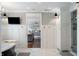 Bright bathroom featuring marble floors, a freestanding tub, and an open doorway to the main bedroom at 4443 Mallard Pt, Columbus, IN 47201