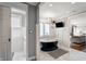 Bright bathroom featuring a freestanding tub, television, and marble floors with a doorway to the water closet at 4443 Mallard Pt, Columbus, IN 47201