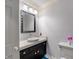 Bathroom featuring a modern vanity, sink, toilet, and decorative pink flowers in a small vase at 4443 Mallard Pt, Columbus, IN 47201