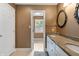 Bathroom featuring double sinks, granite countertops, and a doorway to another room at 4443 Mallard Pt, Columbus, IN 47201