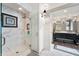 A luxurious bathroom with a glass-enclosed shower, marble tiles, and a stylish vanity at 4443 Mallard Pt, Columbus, IN 47201
