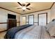 Large bedroom featuring a tv, ceiling fan, and multiple closets, ideal for comfort and lots of storage at 4443 Mallard Pt, Columbus, IN 47201