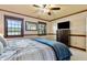 This bedroom features two windows, a ceiling fan, and a wooden dresser with a TV on top at 4443 Mallard Pt, Columbus, IN 47201