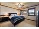 Inviting bedroom with a large bed, ceiling fan, and beautiful trim, offering comfort and style at 4443 Mallard Pt, Columbus, IN 47201