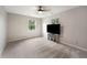 Bright bedroom with two windows, a ceiling fan, and carpet, filled with natural light at 4443 Mallard Pt, Columbus, IN 47201