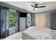 Bright bedroom featuring two windows, carpet, and a ceiling fan, filled with lots of natural light at 4443 Mallard Pt, Columbus, IN 47201
