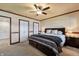 Spacious bedroom with a king bed, ceiling fan, and multiple closets, perfect for relaxation and storage at 4443 Mallard Pt, Columbus, IN 47201