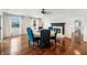 Bright dining room with a fireplace, hardwood floors, and an abundance of natural light overlooking the water at 4443 Mallard Pt, Columbus, IN 47201