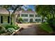 Beautiful two-story home with a long driveway, attractive landscaping, and a blend of brick and light gray siding at 4443 Mallard Pt, Columbus, IN 47201
