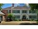 Inviting two-story home with brick and light gray siding, a well-manicured lawn, and a charming front entrance at 4443 Mallard Pt, Columbus, IN 47201