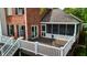 Exterior view of a home featuring a screened porch and backyard deck overlooking the lake at 4443 Mallard Pt, Columbus, IN 47201