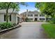 Charming two-story home with a two-car garage, a long driveway, black shutters, and mature trees surrounding the property at 4443 Mallard Pt, Columbus, IN 47201