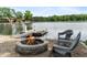 Inviting fire pit area near the lake and dock, offering a cozy space for outdoor gatherings and relaxation at 4443 Mallard Pt, Columbus, IN 47201