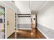 Bright foyer with hardwood floors, elegant wainscoting, coat hooks, and views into adjacent rooms at 4443 Mallard Pt, Columbus, IN 47201