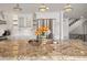 Bright kitchen features a granite island, stainless steel appliances, and custom white cabinetry at 4443 Mallard Pt, Columbus, IN 47201