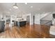 Open-concept kitchen with granite island, stainless steel appliances and adjacent staircase at 4443 Mallard Pt, Columbus, IN 47201