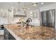 Kitchen island with granite countertops, stainless steel appliances and white cabinetry at 4443 Mallard Pt, Columbus, IN 47201