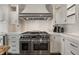Chef's kitchen featuring stainless steel oven and custom range hood at 4443 Mallard Pt, Columbus, IN 47201