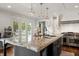 Kitchen island with granite countertops, double sinks, and access to the deck at 4443 Mallard Pt, Columbus, IN 47201