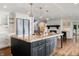 Kitchen with granite island, stainless steel appliances, and fireplace at 4443 Mallard Pt, Columbus, IN 47201