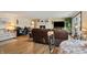 Cozy living room with a fireplace, comfortable seating, and wooden-style flooring at 4443 Mallard Pt, Columbus, IN 47201