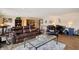 A bright living room with leather furniture, area rug, sauna and backyard views at 4443 Mallard Pt, Columbus, IN 47201