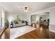 Open-concept living room featuring hardwood floors, natural light, and views into the home office at 4443 Mallard Pt, Columbus, IN 47201