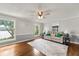 Bright living room with hardwood floors, wainscoting, and scenic lake view at 4443 Mallard Pt, Columbus, IN 47201