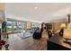 Spacious living room with a fireplace, leather furniture, and glass doors leading to a deck at 4443 Mallard Pt, Columbus, IN 47201