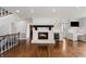 Cozy living room with brick fireplace, hardwood floors, and built-in desk area at 4443 Mallard Pt, Columbus, IN 47201