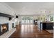 Open living space featuring a fireplace, hardwood floors, and an open concept kitchen at 4443 Mallard Pt, Columbus, IN 47201
