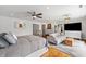 Spacious main bedroom with hardwood floors, large bed, sitting area, and ensuite bathroom at 4443 Mallard Pt, Columbus, IN 47201