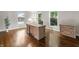 Bright home office with a desk, filing cabinet, hardwood floors, and large windows at 4443 Mallard Pt, Columbus, IN 47201