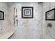 Detail shot of a tiled shower with marble accents, bench seat and chrome showerhead at 4443 Mallard Pt, Columbus, IN 47201