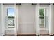 Large windows with white trim showcase the stunning waterfront view and bring natural light into the space at 4443 Mallard Pt, Columbus, IN 47201