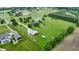Aerial view of a sprawling estate, highlighting the lush grounds and equestrian facilities at 4670 N 600 E, Franklin, IN 46131
