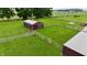 Overhead shot of barn with fenced pastures, showcasing the equestrian setup of the property at 4670 N 600 E, Franklin, IN 46131