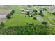 Aerial of the property with horse training track and pond in a landscape of vibrant greenery at 4670 N 600 E, Franklin, IN 46131