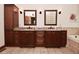 Double vanity bathroom with granite countertops and framed mirrors offers ample storage at 4670 N 600 E, Franklin, IN 46131