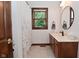 Bright bathroom with updated vanity, fixtures, large window, and neutral tile floors at 4670 N 600 E, Franklin, IN 46131