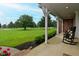 Relaxing front porch with rocking chairs offering a scenic view of the expansive lawn and surrounding greenery at 4670 N 600 E, Franklin, IN 46131