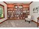Cozy living room with custom built-in bookcase, a comfortable chair, plush carpet, and plenty of natural light at 4670 N 600 E, Franklin, IN 46131