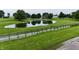 Scenic pond with lush green surroundings, split rail fence, and mature trees, located on a sprawling lot at 4670 N 600 E, Franklin, IN 46131